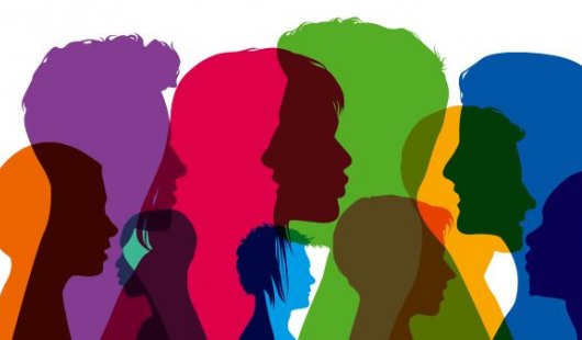 a series of overlapping silhouettes of heads in profile in different colours